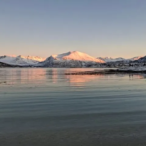 Pink dusk over the fjord and the mountains
