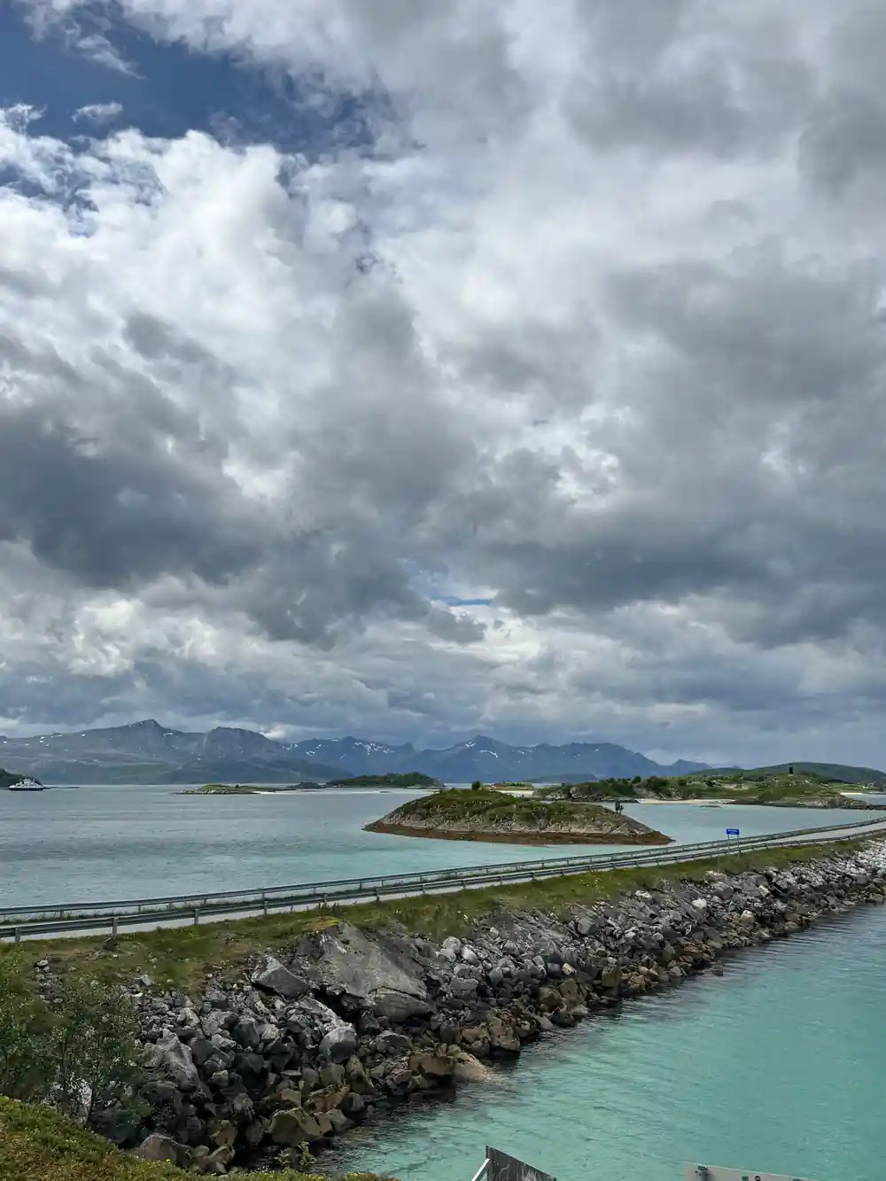 A coastal road and bridge under a heavy sky