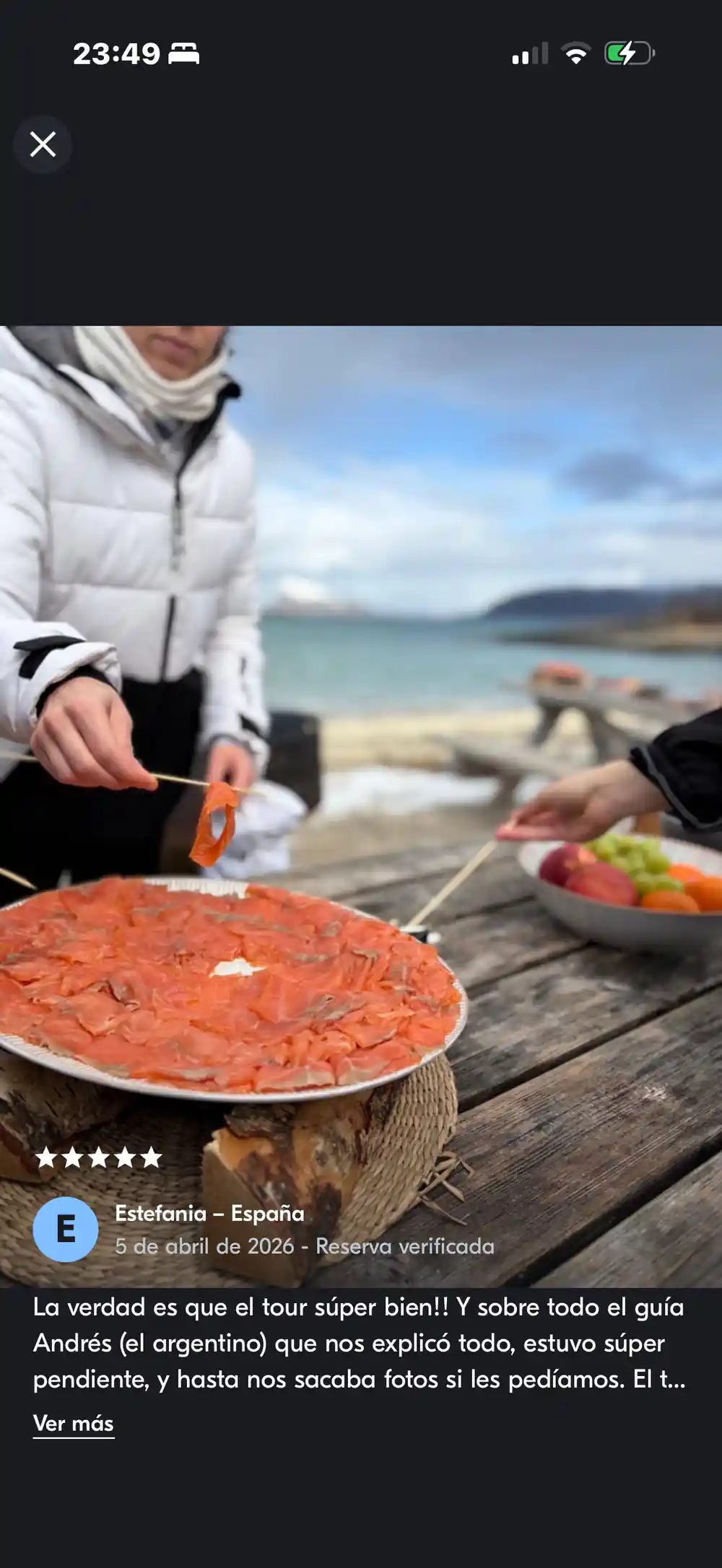 A guest preparing skewers beside a platter of salmon